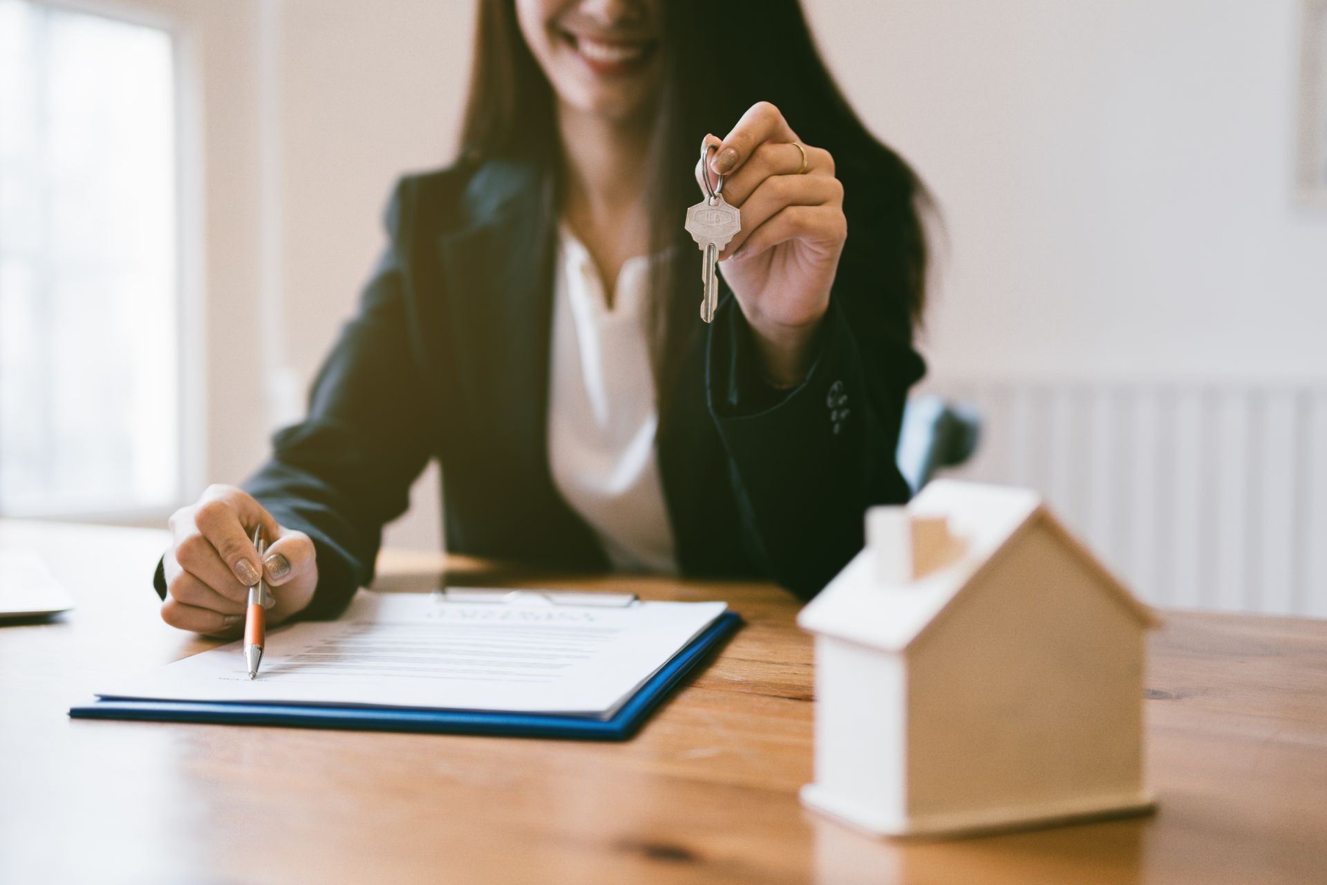 Realtor is giving the keys to an apartment to clients. Focus on the keys.